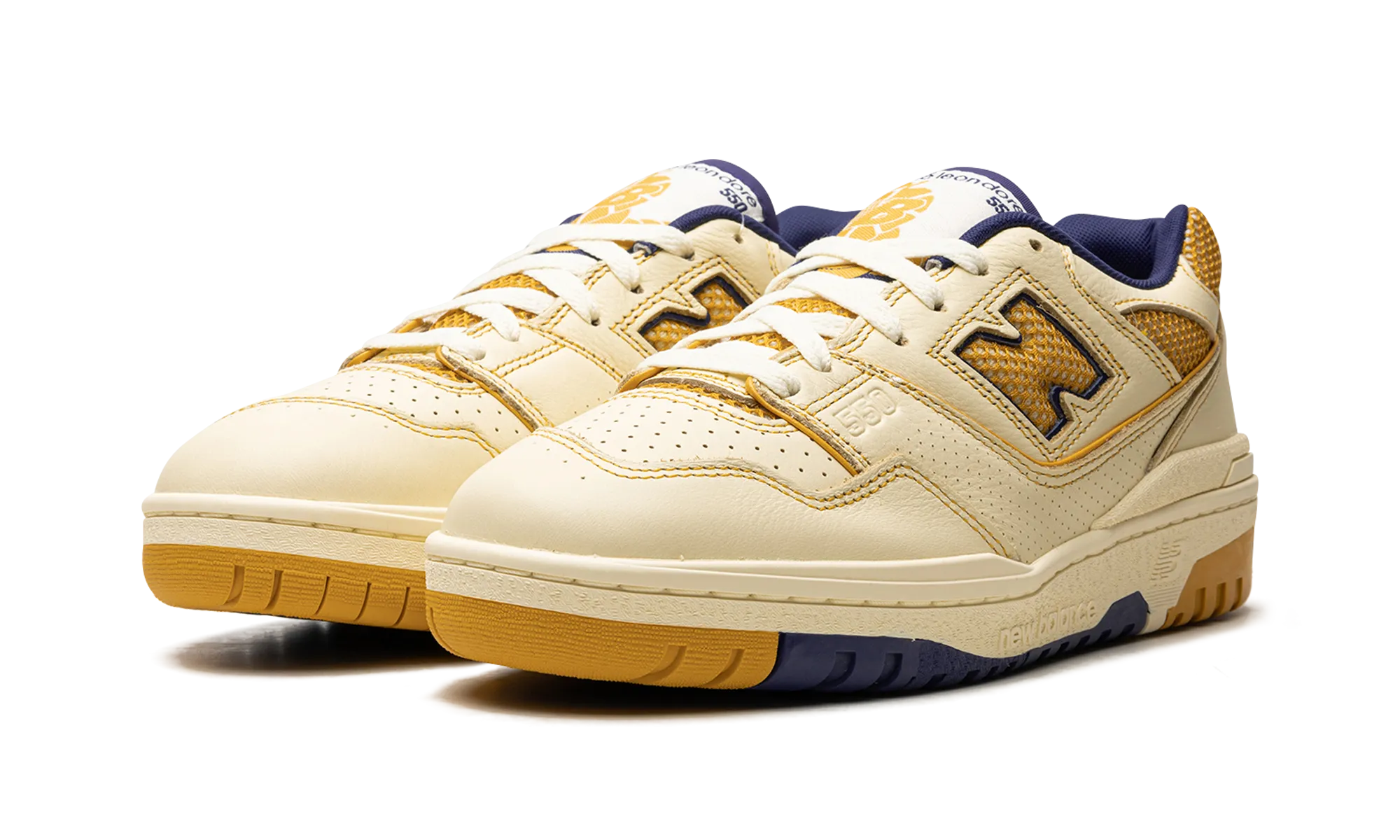 550 "Aime Leon Dore - White / Yellow" running on a gravel road
