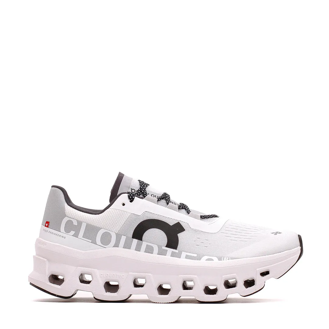 ON Women Cloudmonster White Core 61.98433 running in a suspension cable bridge area shoes